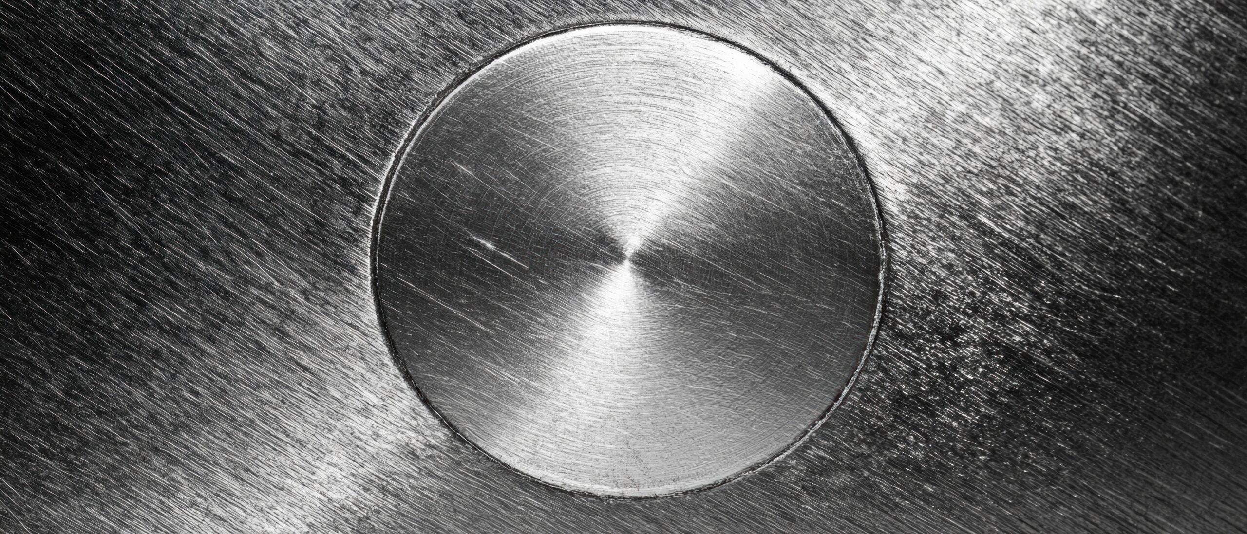 Gros plan sur la texture brossée d'un potelet en inox installé sur trottoir